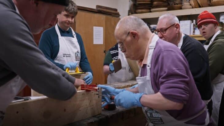 A photo of a group of men working in a woodshop as part of the the "Sensory Gardens" project from Men's Sheds and Irish Hospice Foundation.