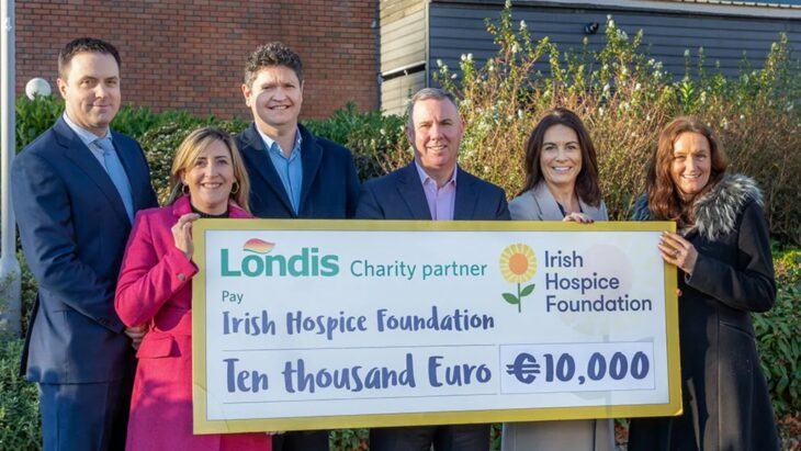 A photo of six people, three men and three women, holding a large check for the amount of 10,000 euro. Irish Hospice Foundation is the new charity partner for Londis.