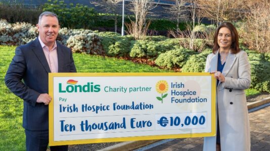 A photo of two people holding a large check for the amount of 10,000 euro. Irish Hospice Foundation is the new charity partner for Londis.