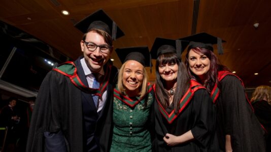 A photo of four smiling students (one man and three women) from Irish Hospice Foundation's MSc Loss and Bereavement programme.